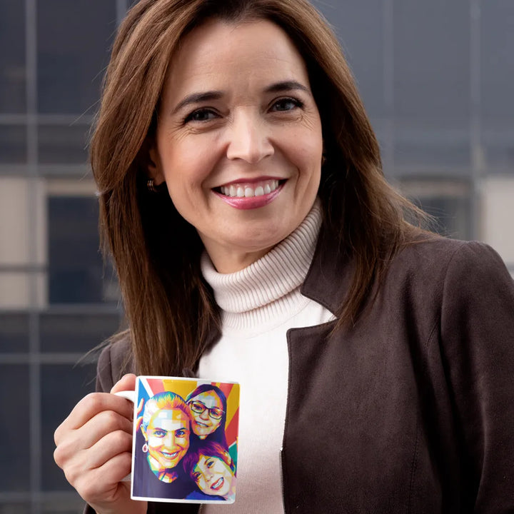 Woman holding a mug with a colorful design of two faces against a tiled wall background
